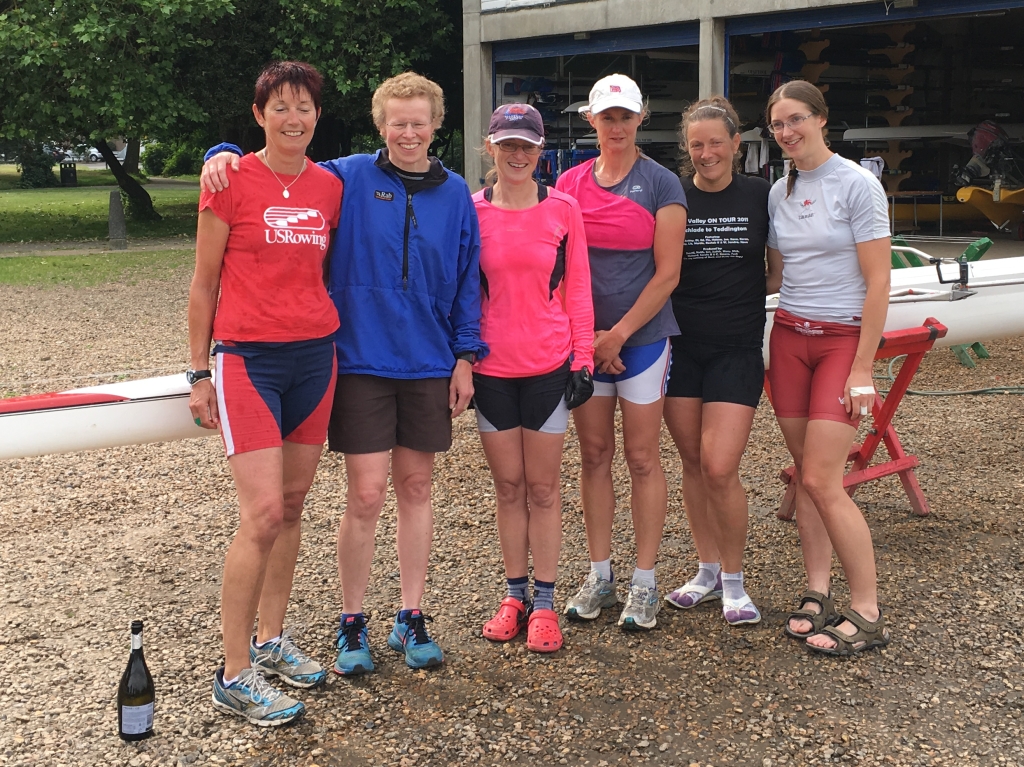 6 women standing in front of boathouse